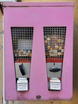Eine alter Kaugummiautomat in rosa Farbe