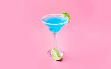Blue cocktail with tequila, liqueur, lime juice, salt and ice, pink background, negative space
