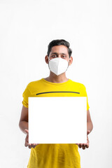 Young Indian man showing blank sing board over white background