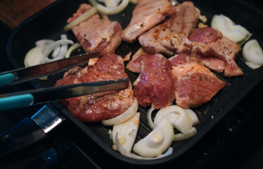 Meat grilling on the cooking pan