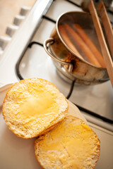 
boiling sausages in a pot for breakfast with a roll with cheese