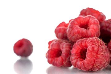 Several berries of ripe red raspberries, close-up, isolated on white.