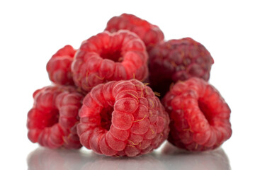Several berries of ripe red raspberries, close-up, isolated on white.
