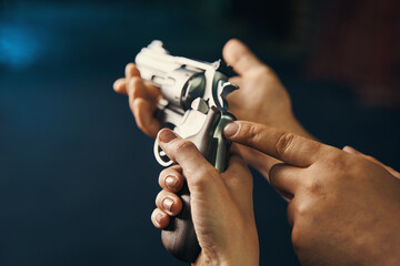 Female learning to handle a gun assisted by a certified instructor