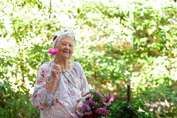 Portrait of a blond senior woman with an active lifestyle enjoying retirement during work in the garden in a sunny day of summer