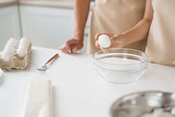 Close up of woman anf her daughter cooking dough in kitchen