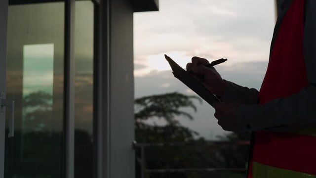 Audit engineers are jotting down inspection details on over time refer customer request. The contractor writes down the details after revising according to the customer inform.  inspection concept