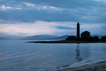 Silhouette of the Battle of Largs Pencil Monument at sunset, Largs, Scotland