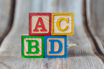 ABC wooden block on table.
