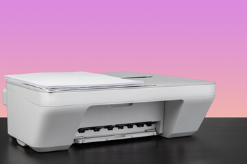 Compact home laser printer against pink background