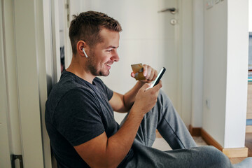 Internet online banking. A person in a relaxed home atmosphere does business via the internet application, benefits from online business, beliefs in internet banking, saving your free time