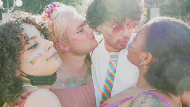 Happy queer people laughing and kissing