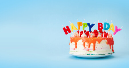 Birthday cake with candles on a blue