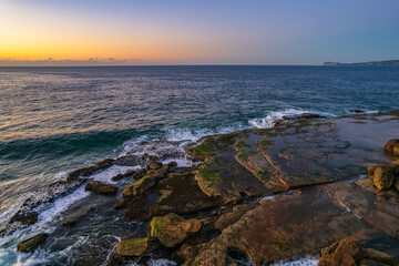 Aerial sunrise over the sea with clear skies