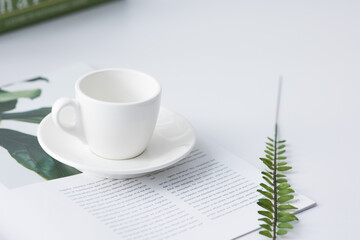 white coffee cup on a white table.