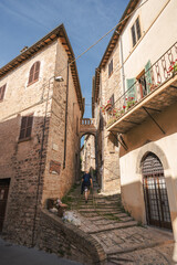 A young man walk along the beautiful streets of Spello, Umbria