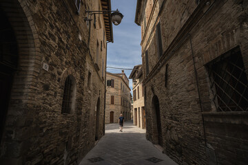 Fototapeta na wymiar A young man walk along the streets of Bevagna, Umbria