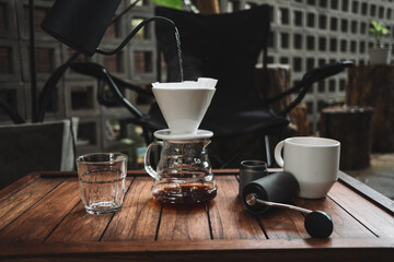 barista dripping coffee and slow coffee wooden bar style