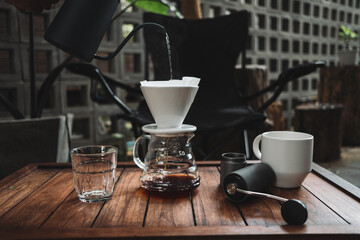 barista dripping coffee and slow coffee wooden bar style
