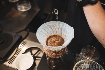 barista dripping coffee and slow coffee wooden bar style