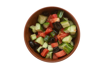 Top view on a bowl of homemade vegetable salad with tomatoes, cucumbers and black olives, isolated on white background.