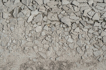 Slate fragments erased into ashes are thrown out into the street. Asbestos carcinogenic slate. Close up, textured.