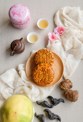 popular snacks and food eaten during mid-autumn festival. mooncake, Chinese Tea, Taro, Water Caltrop and Pomelo. The Chinese character translate as double egg yolk lotus paste and red bean paste