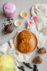 popular snacks and food eaten during mid-autumn festival. mooncake, Chinese Tea, Taro, Water Caltrop and Pomelo. The Chinese character translate as double egg yolk lotus paste and red bean paste