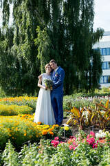 Happy young bride and groom on  wedding day. Wedding couple - new family! wedding dress. Bridal wedding bouquet of flowers