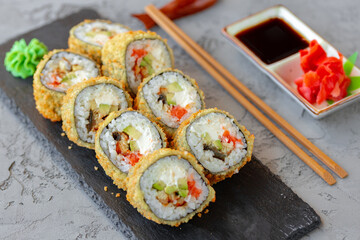 Japanese sushi tempura roll served on black stone plate © fotofabrika