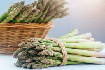 Asparagus. Fresh raw organic green Asparagus sprouts closeup. Basket and bunch n the table. Healthy vegetarian food. Raw vegetables, market. Healthy eating concept, diet, dieting. 