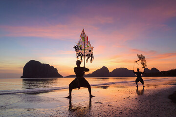 Traditional Thailand Shadow Puppet Show at beach on during sunset,shadow puppets