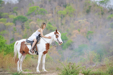 Cowgirl working stables.Concept of retro woman in horse ranch.vintage style