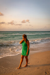 Girl walks along the beach in a dress