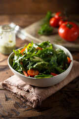 Healthy arugula salad with tomato and cucumber