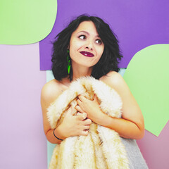 Beautiful model with  dark red lipstick, a white faux fur coat and earrings on a pop art background...
