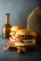 Traditional homemade cheeseburgers with lettuce and onion