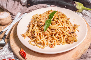 Traditional Sicilian pasta dish of sauteed eggplant topped with tomato sauce