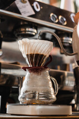 
Arabic coffee filter and hot water that pours in a cafe on a sunny day