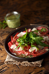 Traditional homemade beef carpaccio with arugula