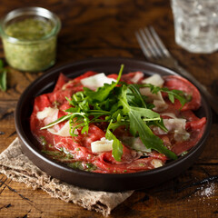 Traditional homemade beef carpaccio with arugula