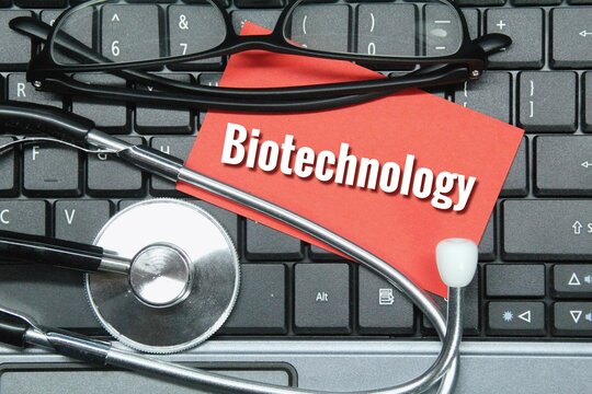 glasses, laptop keyboards, stethoscopes, colored paper with the word biotechnology