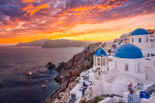 Stunning traveling destination scenic. Oia, Santorini island Greece. Amazing sunset sky with blue domes, caldera view, white architecture, luxury vacation in Europe. Famous popular landscape cityscape