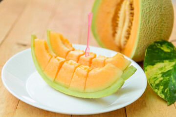 a lot of piece of fresh orange melon on the plate