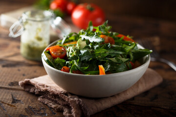 Healthy arugula salad with tomato and cucumber