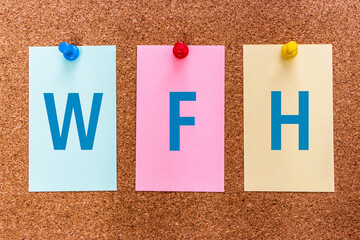 Conceptual 3 letter acronym abbreviation WFH (Work from Home) on multicolored stickers attached to...