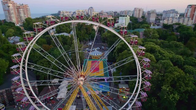 aerial view of entertainment park in the evening with ferris wheel 