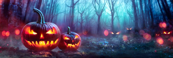 Foto op Plexiglas Halloween Pumpkins In A Spooky Forest At Night With Evil Eyes © Romolo Tavani