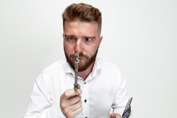 Portrait of funny bearded man, builder, designer or architect with professional equipment isolated on white studio background.