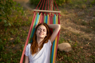 Fototapeta premium pretty woman lies in a hammock outdoors nature trees